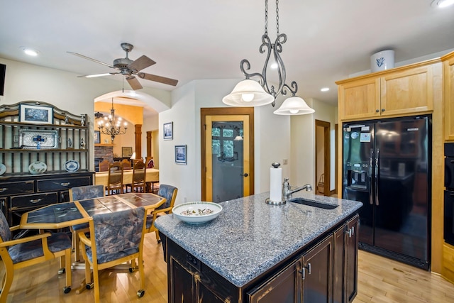 35365 Boot Lake Rd, Park Rapids, MN 56470 - kitchen featuring light wood-type flooring, black appliances, arched walkways, and a sink