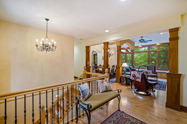 35365 Boot Lake Rd, Park Rapids, MN 56470 - hallway with arched walkways, an upstairs landing, a chandelier, ornate columns, and hardwood / wood-style flooring