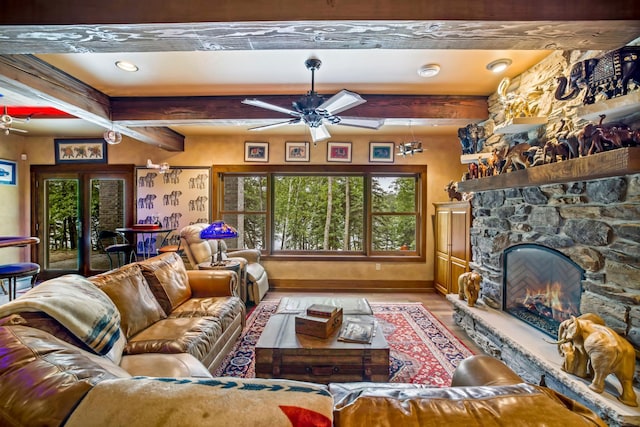 35365 Boot Lake Rd, Park Rapids, MN 56470 - living room featuring a ceiling fan, a fireplace, beamed ceiling, and baseboards