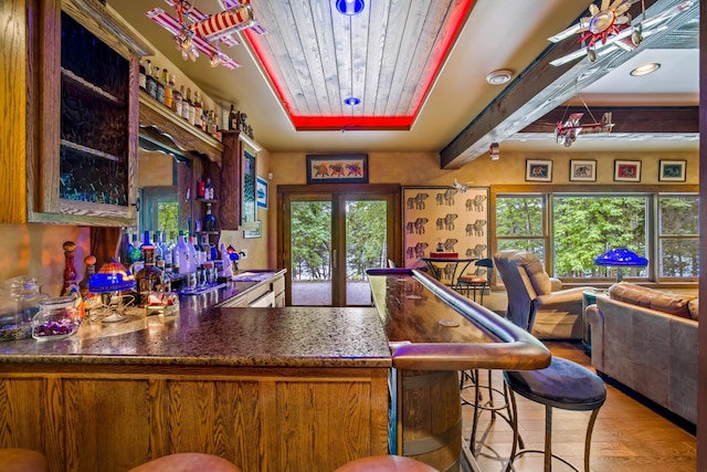 35365 Boot Lake Rd, Park Rapids, MN 56470 - bar featuring beam ceiling, french doors, a bar, wood finished floors, and wooden ceiling