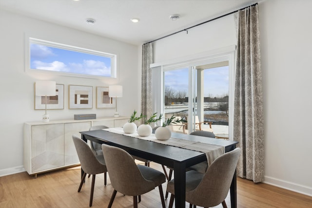 dining room featuring light wood-style floors and baseboards