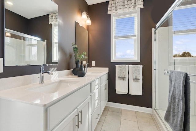 full bath with double vanity, tile patterned flooring, a sink, and a shower stall