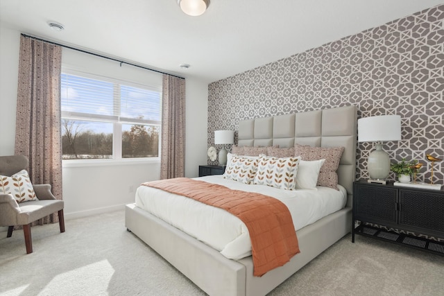 carpeted bedroom with baseboards, an accent wall, and wallpapered walls