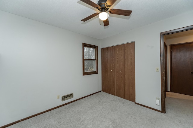 unfurnished bedroom featuring carpet floors, a closet, visible vents, and baseboards