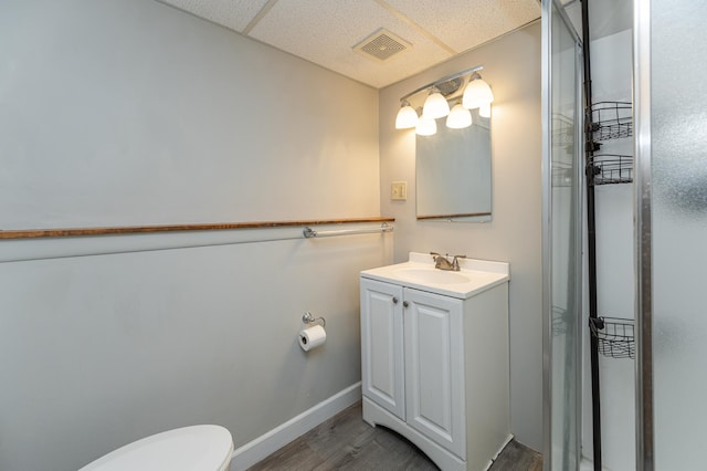 full bathroom featuring baseboards, visible vents, toilet, wood finished floors, and vanity