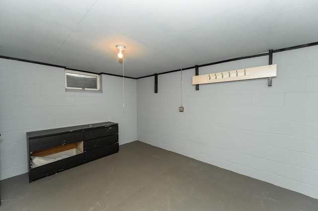 finished basement featuring concrete block wall