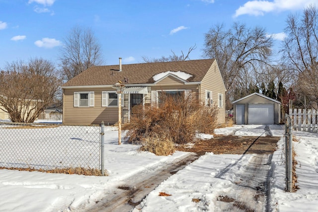 view of front facade featuring an outbuilding, fence, a garage, and roof with shingles