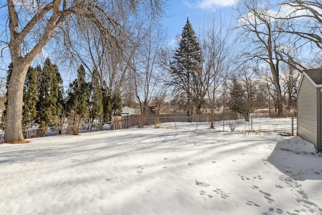 yard covered in snow with fence