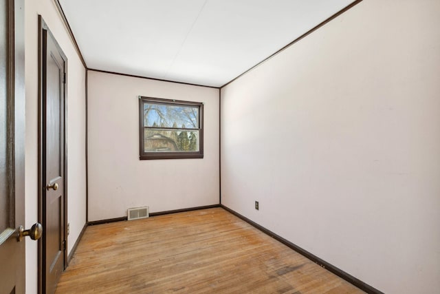 unfurnished bedroom with light wood-style floors, visible vents, and baseboards