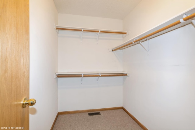 walk in closet with carpet flooring and visible vents