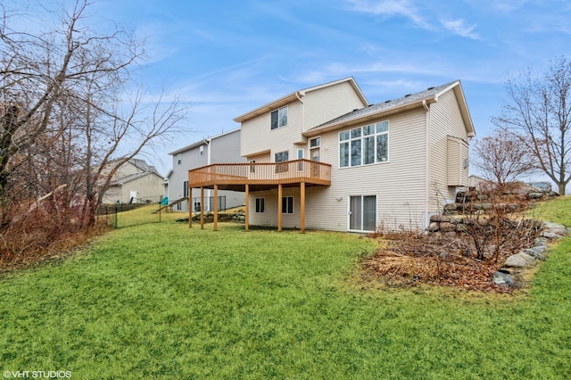 back of house featuring a wooden deck, fence, and a yard