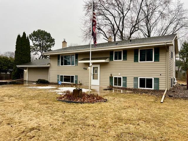 view of front of house with a chimney and a front yard