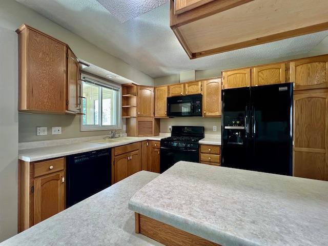 kitchen with brown cabinetry, light countertops, black appliances, and open shelves