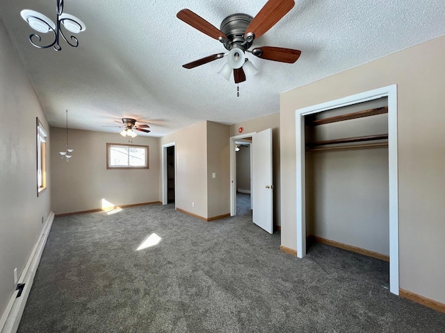 unfurnished bedroom with a textured ceiling, carpet, a baseboard radiator, and baseboards