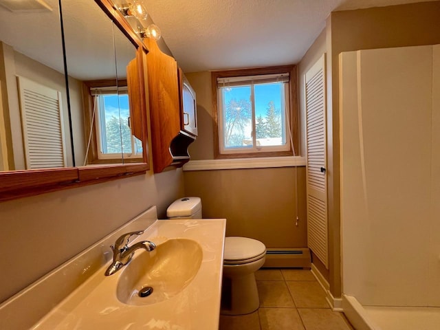 full bathroom featuring a wealth of natural light, a baseboard radiator, a closet, and tile patterned flooring