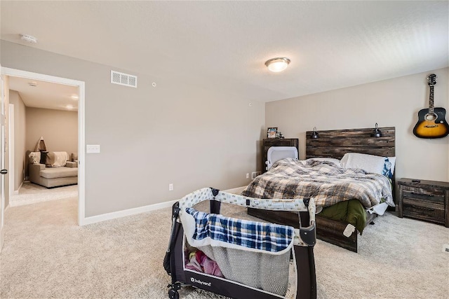 bedroom with carpet, visible vents, and baseboards