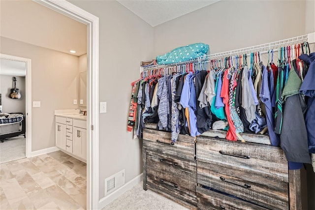 spacious closet with a sink and visible vents