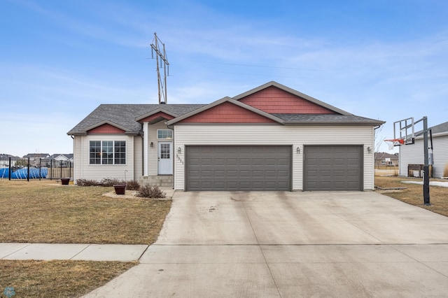 ranch-style home with driveway, a garage, a shingled roof, fence, and a front yard