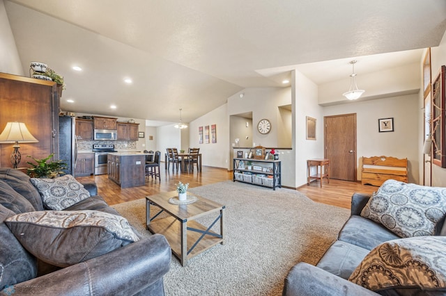 living room with light wood-type flooring, vaulted ceiling, baseboards, and recessed lighting