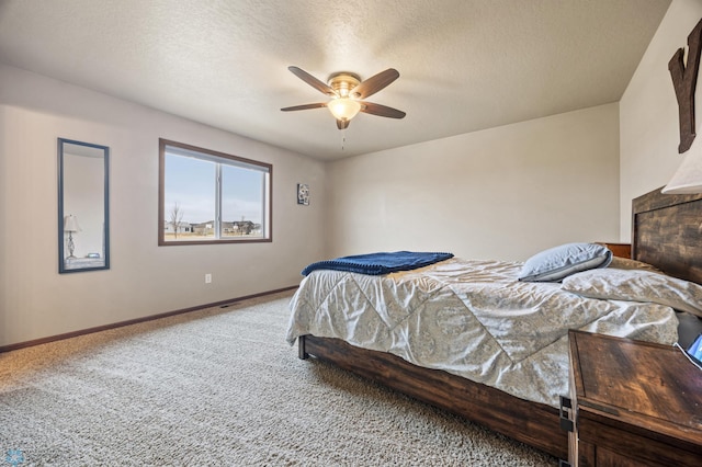 carpeted bedroom featuring a ceiling fan, a textured ceiling, and baseboards