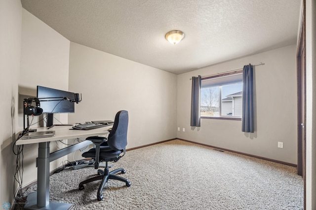 office space with carpet, a textured ceiling, and baseboards