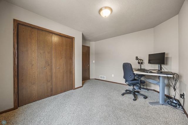 office space with carpet, visible vents, and baseboards