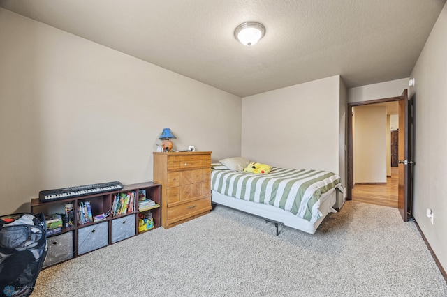 carpeted bedroom featuring a textured ceiling