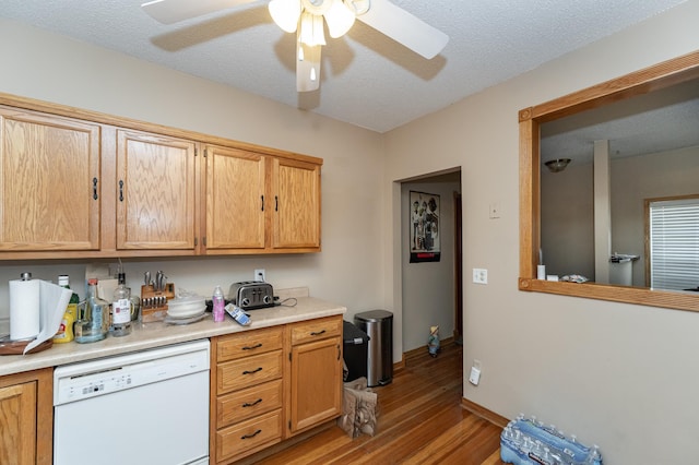 kitchen featuring light wood finished floors, a ceiling fan, dishwasher, light countertops, and a textured ceiling