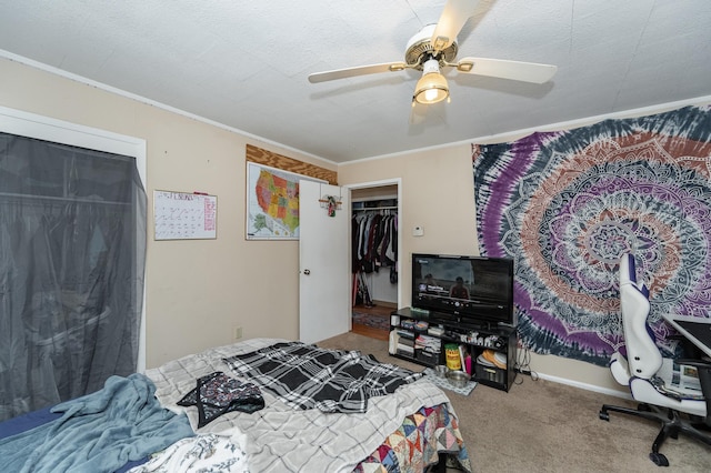 carpeted bedroom with crown molding and ceiling fan