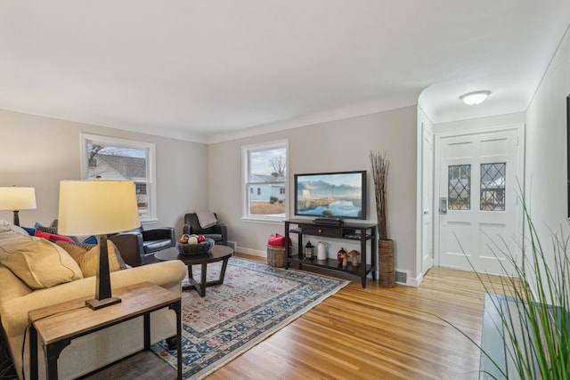 living room with light wood-type flooring and baseboards