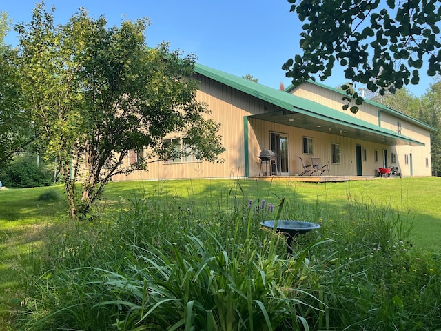 rear view of property with a yard