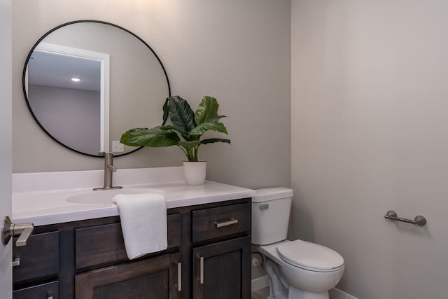 half bathroom featuring toilet and vanity