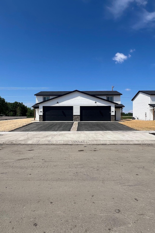 3112 Scotch Ln, Mankato, MN 56001 - view of front of house featuring a garage, an outdoor structure, and asphalt driveway