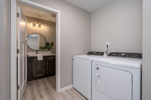 3112 Scotch Ln, Mankato, MN 56001 - laundry room with washing machine and clothes dryer, light wood finished floors, and baseboards