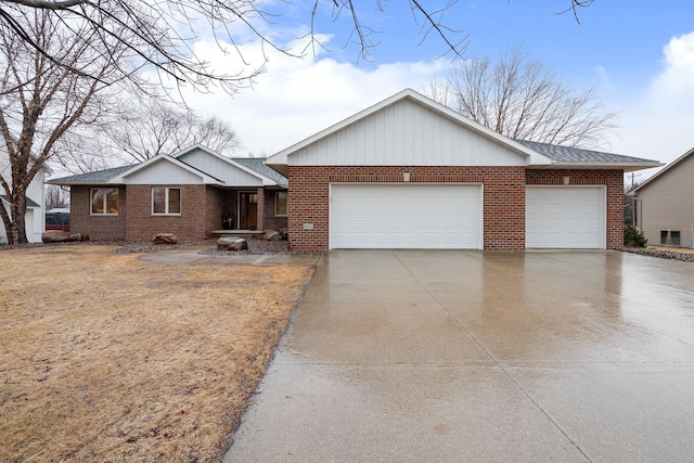 ranch-style house with a garage, brick siding, and driveway