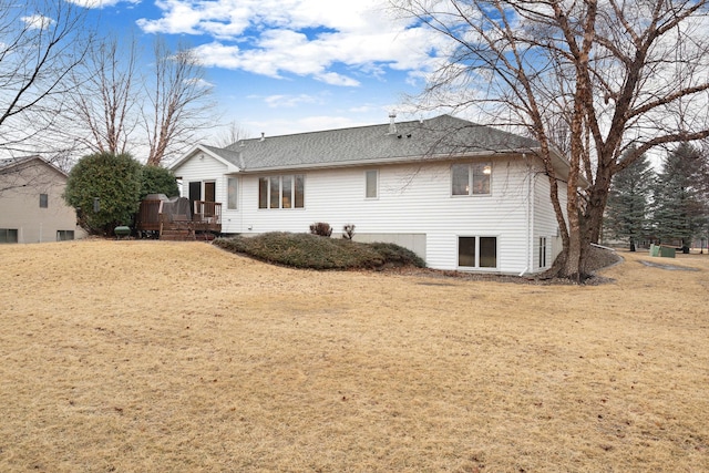 back of house with a lawn and a deck