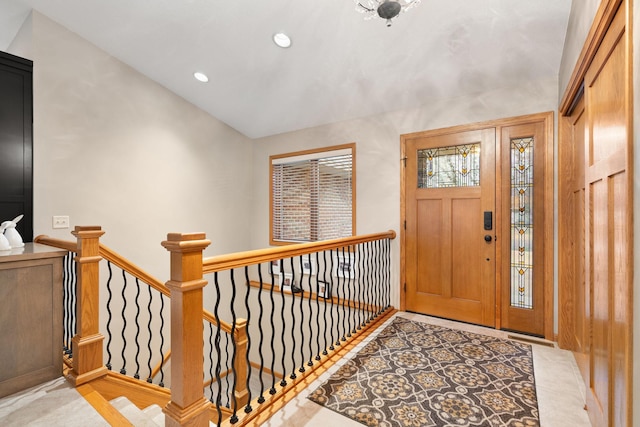 foyer entrance featuring lofted ceiling and recessed lighting