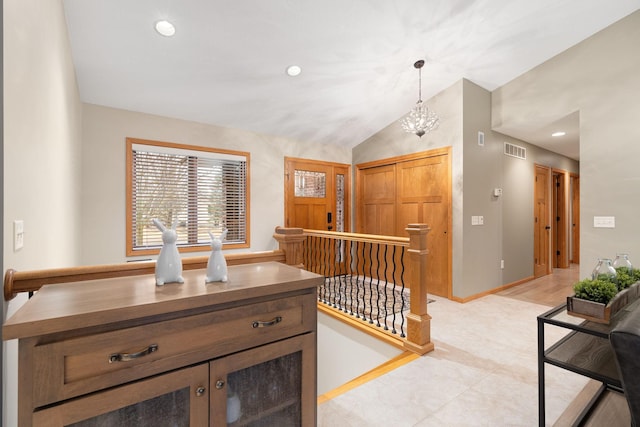 corridor featuring a chandelier, recessed lighting, visible vents, baseboards, and vaulted ceiling