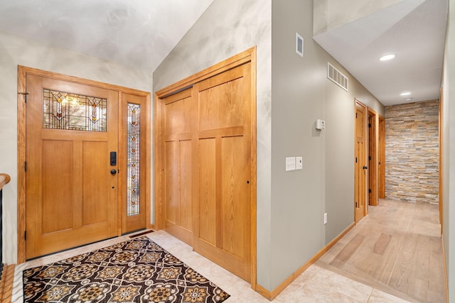 entrance foyer with lofted ceiling, recessed lighting, visible vents, and baseboards