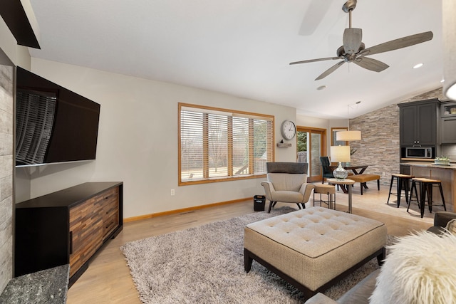 living room featuring recessed lighting, vaulted ceiling, light wood-style flooring, and baseboards