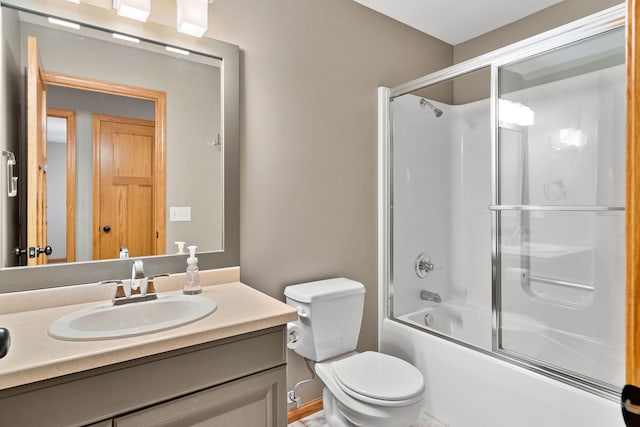 full bath featuring toilet, combined bath / shower with glass door, and vanity