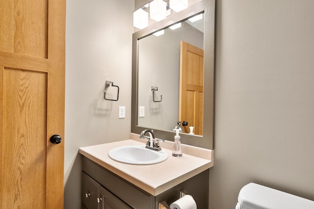 bathroom featuring vanity and toilet