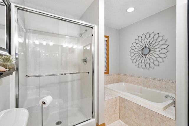 bathroom with a stall shower and a bath