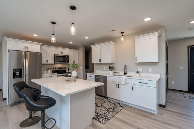 3108 Scotch Ln, Mankato, MN 56001 - kitchen with appliances with stainless steel finishes, a sink, light wood finished floors, white cabinets, and recessed lighting