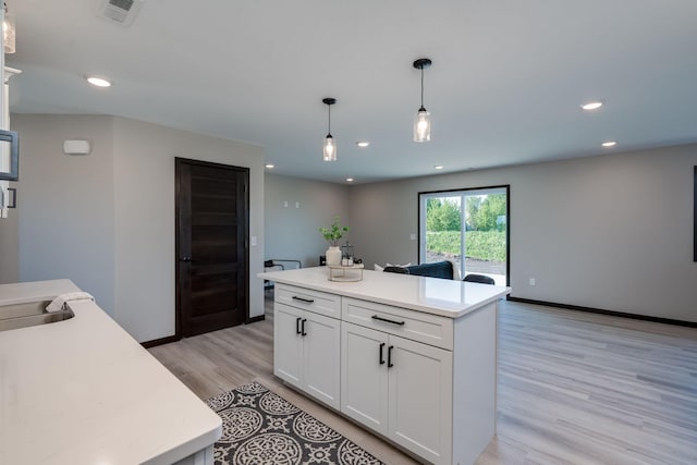 3108 Scotch Ln, Mankato, MN 56001 - kitchen featuring white cabinetry, decorative light fixtures, light wood-style flooring, light countertops, and recessed lighting