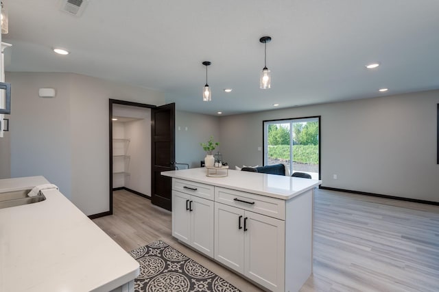 3108 Scotch Ln, Mankato, MN 56001 - kitchen featuring white cabinets, light wood finished floors, pendant lighting, light countertops, and recessed lighting