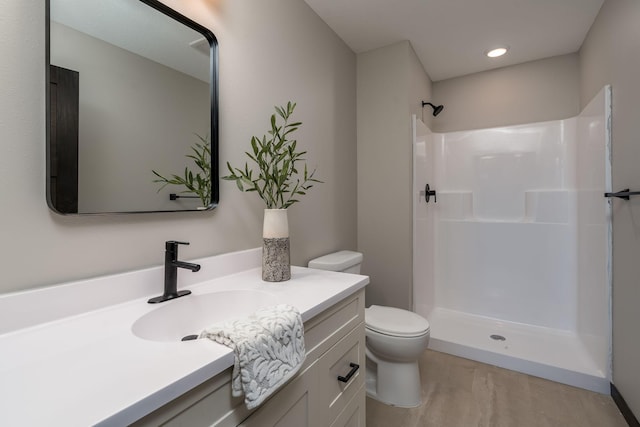 3108 Scotch Ln, Mankato, MN 56001 - full bath featuring toilet, a shower, vanity, and wood finished floors