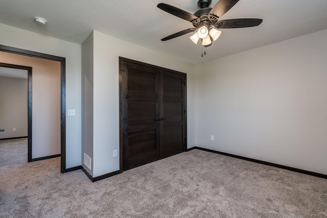 3108 Scotch Ln, Mankato, MN 56001 - unfurnished bedroom featuring light carpet, baseboards, a closet, and ceiling fan