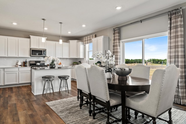 dining room with dark wood-style flooring and recessed lighting