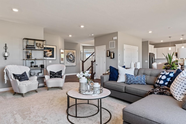 living room featuring recessed lighting, visible vents, stairway, and baseboards